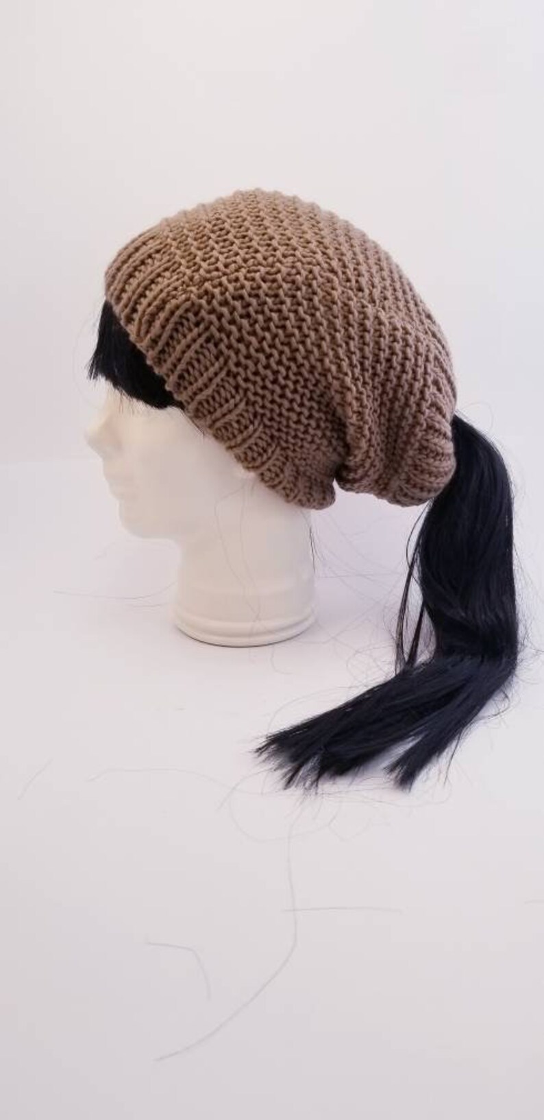 Taupe slouchy beanie with an elastic ponytail top opening great for any winter activity with style the comfort and the warmth.