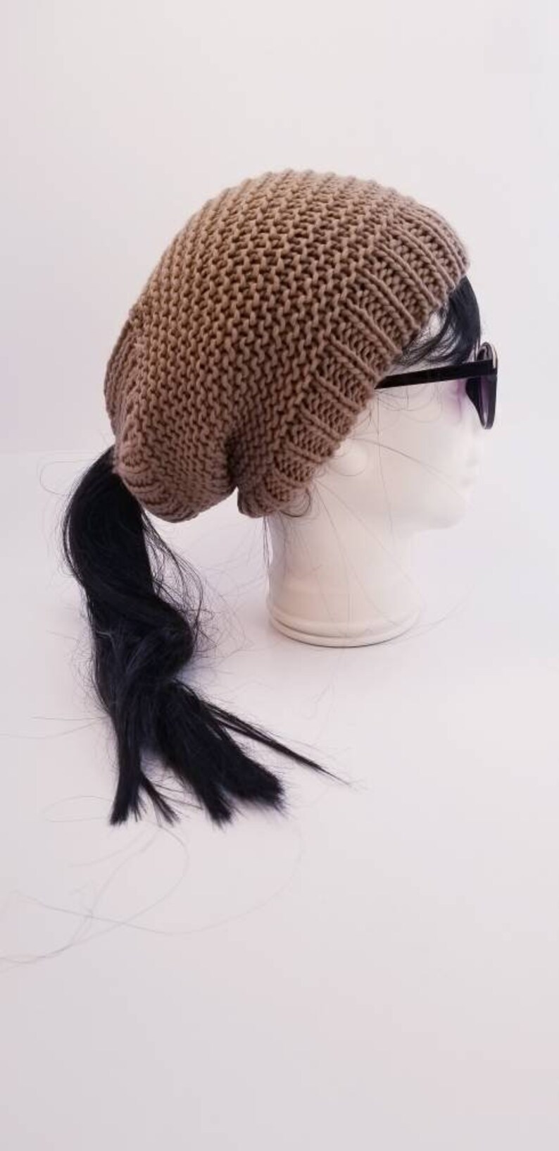 Taupe slouchy beanie with an elastic ponytail top opening great for any winter activity with style the comfort and the warmth.