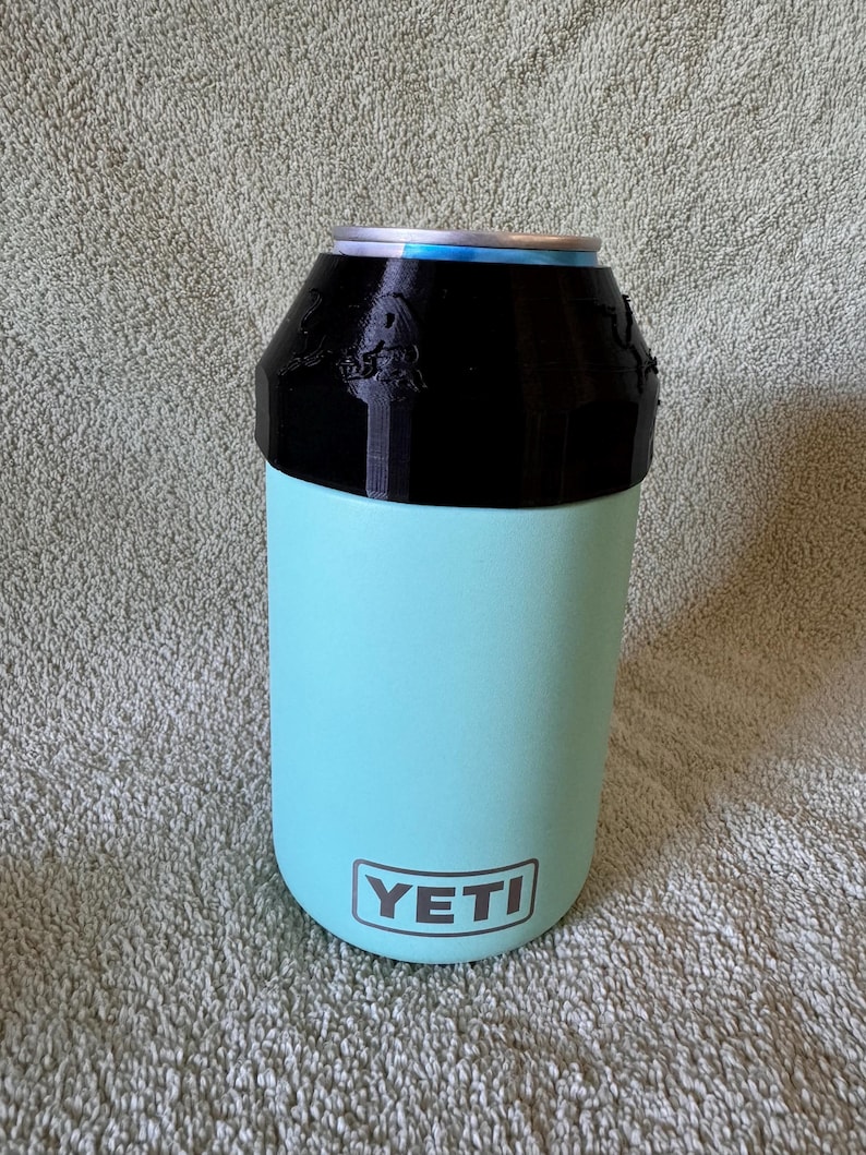 Red Bull 8.4oz Lid & can with Newer Quick Turn YETI colster can cooler (type 2) made for 12oz standard cans. Prancing Bull version shown in black.