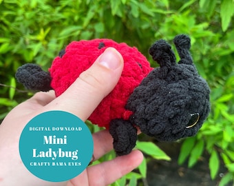 May include: A crocheted ladybug toy with a red body, black spots, and black head with a single black eye. The toy is being held in a hand. The text "Digital Download Mini Ladybug Crafty Bama Eyes" is on a teal circle.