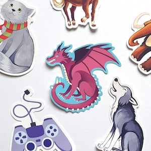 May include: A set of six colorful stickers featuring a purple dragon, a gray cat wearing a red and green scarf, a brown horse, a gray wolf, a brown mammoth, and a purple video game controller.