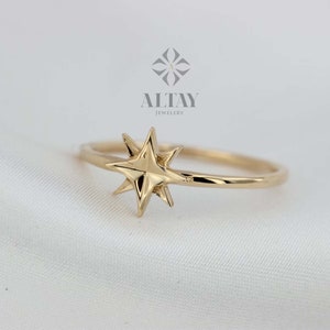 May include: A gold ring with a star-shaped design. The ring is simple and elegant, and the star is a classic symbol of hope and guidance.
