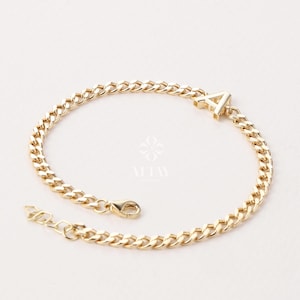 May include: Gold-coloured curb chain bracelet with the letter "A" charm. The bracelet has a lobster clasp closure and an adjustable chain. The jewellery is displayed on a white background. The bracelet is a stylish accessory.