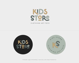May include: Two logo designs for a kids store. The first logo is a stylised text design in beige and grey that says "KIDS STORE" with the text "CLOTHING ART TOYS" below. The second logo is a circle with a black background and a stylised text design in beige and grey that says "KIDS STORE". The third logo is a circle with a light green background and a stylised text design in beige and grey that says "KIDS STORE" with the letters "KS" in the centre.