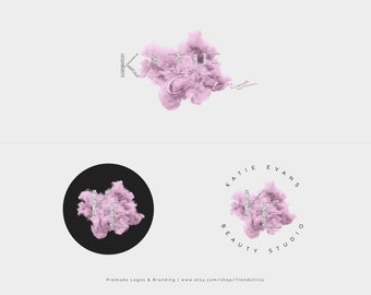 May include: A logo design featuring the name "Katie Evans" in a silver glitter font. The name is placed over a pink cloud-like shape. The logo also includes a circular version with the initials "KE" in silver glitter font over a pink cloud-like shape. The text "Katie Evans Beauty Studio" surrounds the circular logo.