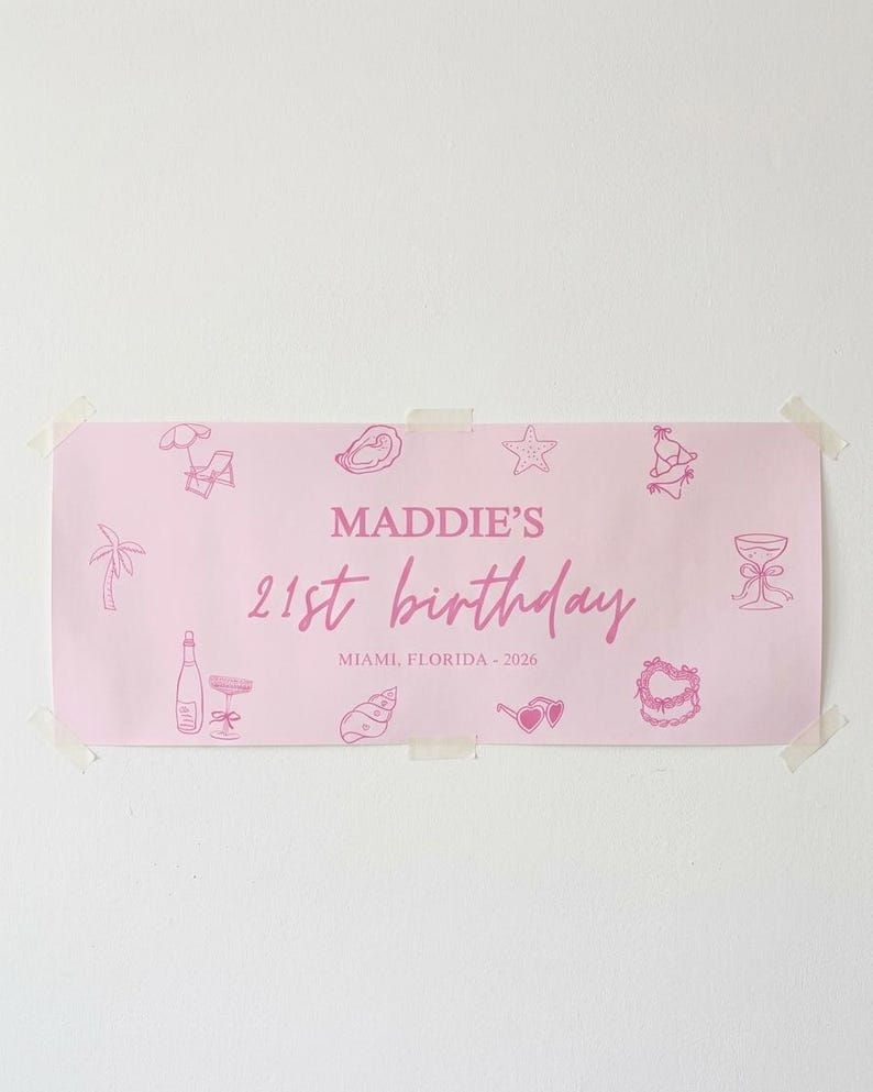 May include: A pink banner with the text "MADDIE'S 21st birthday" and "MIAMI, FLORIDA - 2026" in a cursive font. The banner is decorated with pink illustrations of a palm tree, champagne bottle, sunglasses, and other party-themed graphics.