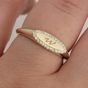 Pinky diamond signet ring in solid 14K gold close-up detail