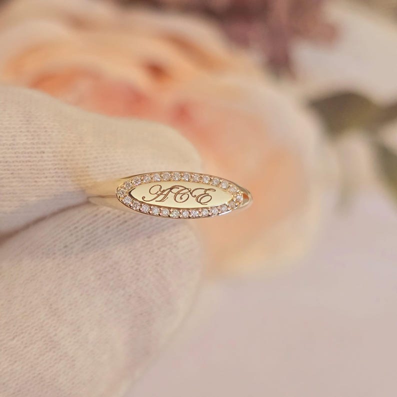 Personalized diamond signet ring engraved surface lifestyle shot