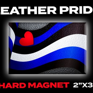 May include: A hard magnet featuring a leather pride flag with a red heart in the center. The flag has black, white, and blue stripes. The magnet is 2 inches by 3 inches.