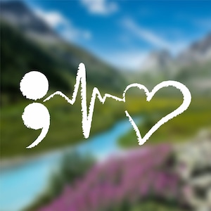 May include: White semicolon, heartbeat, and heart drawn on a blurred background of a mountain landscape with a river.