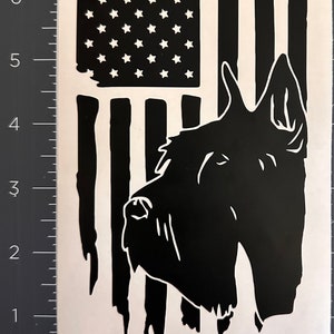May include: Black and white graphic of an American flag with a dog silhouette. The flag design features stars and stripes, with a dog's profile superimposed on the right side. The dog's features are detailed, and the flag has a distressed look.