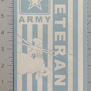 May include: A white vinyl sticker with a blue background. The sticker features a silhouette of a helicopter, the words "VETERAN" and "ARMY" in white, and a blue star inside a square.