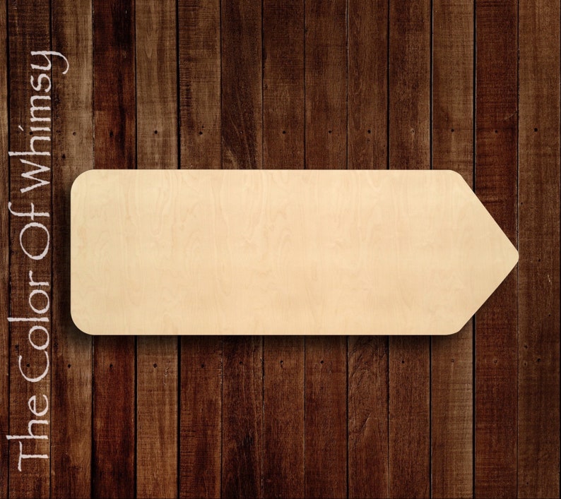 May include: A wooden arrow sign with a rounded top and a pointed tip. The sign is blank and ready to be painted or decorated. The sign is made of natural wood and has a light brown color.
