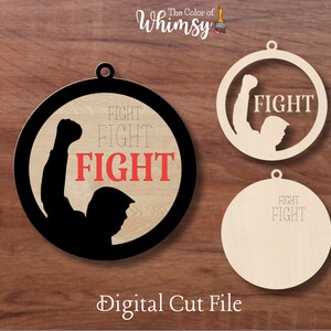 May include: Three round wooden ornaments with a black silhouette of a person raising a fist. The ornaments have the word "FIGHT" written on them in red and white text.