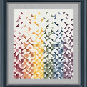 Puede incluir: Un patrón geométrico colorido con un esquema de colores arcoíris. El patrón está formado por pequeños cuadrados y triángulos. El fondo es blanco.