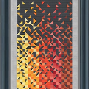 May include: A framed abstract geometric art print with a gradient of yellow, orange, and red triangles on a black background.