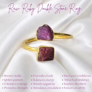 May include: A gold-toned open ring featuring two raw, deep pink ruby stones. The text "Raw Ruby Double Stone Ring" appears at the top, with a list of benefits including "Boosts vitality," "Ignites passion," and "Increases confidence" printed below.