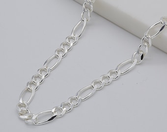 May include: A silver chain necklace with a figaro link pattern.