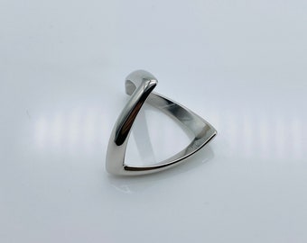 May include: A silver triangle shaped ring with a pointed tip.