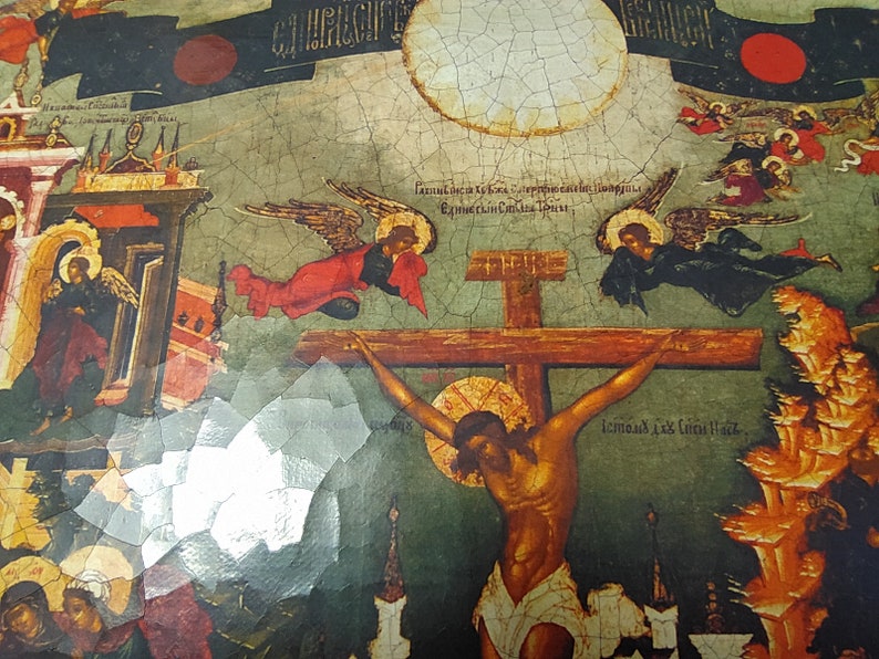May include: An antique religious icon depicting the crucifixion of Jesus Christ. The artwork features a central cross with a figure, angels, and architectural elements. The color palette includes reds, blues, and golds, with visible text in the upper portion.