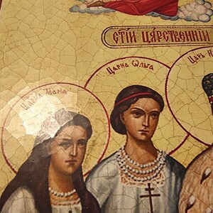 May include: A vintage religious icon depicting a family with the text "СТИ ЦАРСТВЕННЫЙ" (Royal Family) in Cyrillic script. The icon features a woman with a red headband and a pearl necklace, a woman with long dark hair, and a man with a crown and beard. The icon is painted on a cracked, yellow background.