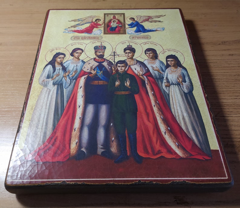 May include: A religious icon depicting a family of saints. The icon features a central image of a king and queen, with their son standing between them. The king and queen are wearing elaborate robes, while the son is dressed in a simple tunic. The icon also includes images of angels and other saints.