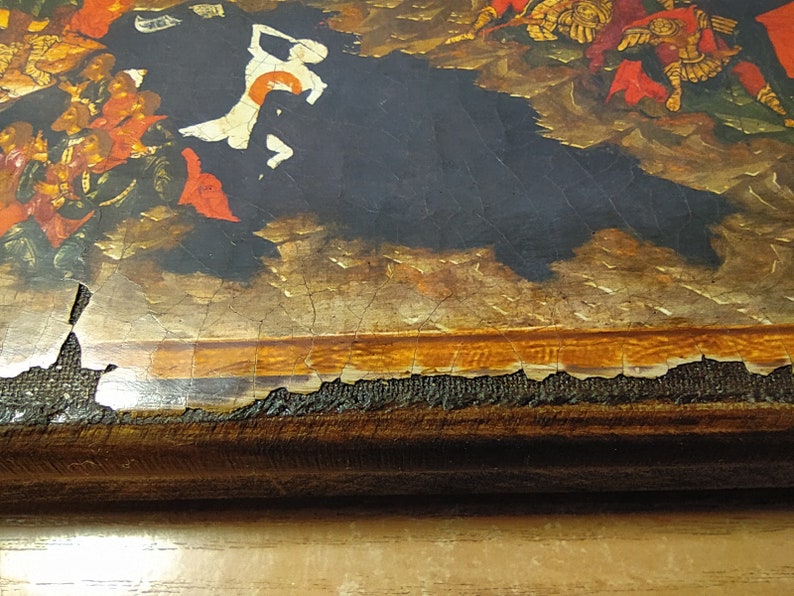 May include: Close-up of a section of a painting with a dark background and figures in red, gold, and white. The painting has visible cracks and damage along the edges, revealing the canvas and wooden frame.