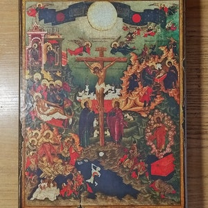 May include: A religious icon depicting the crucifixion of Jesus Christ. The artwork features a central figure on a cross, surrounded by other figures and angels. The color palette includes reds, blues, and golds, with a distressed, aged appearance.