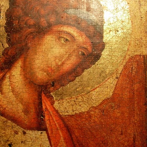 May include: A close-up of a painting depicting a person with red hair and a red and gold robe. The painting is on a wooden panel and has a cracked and aged appearance.