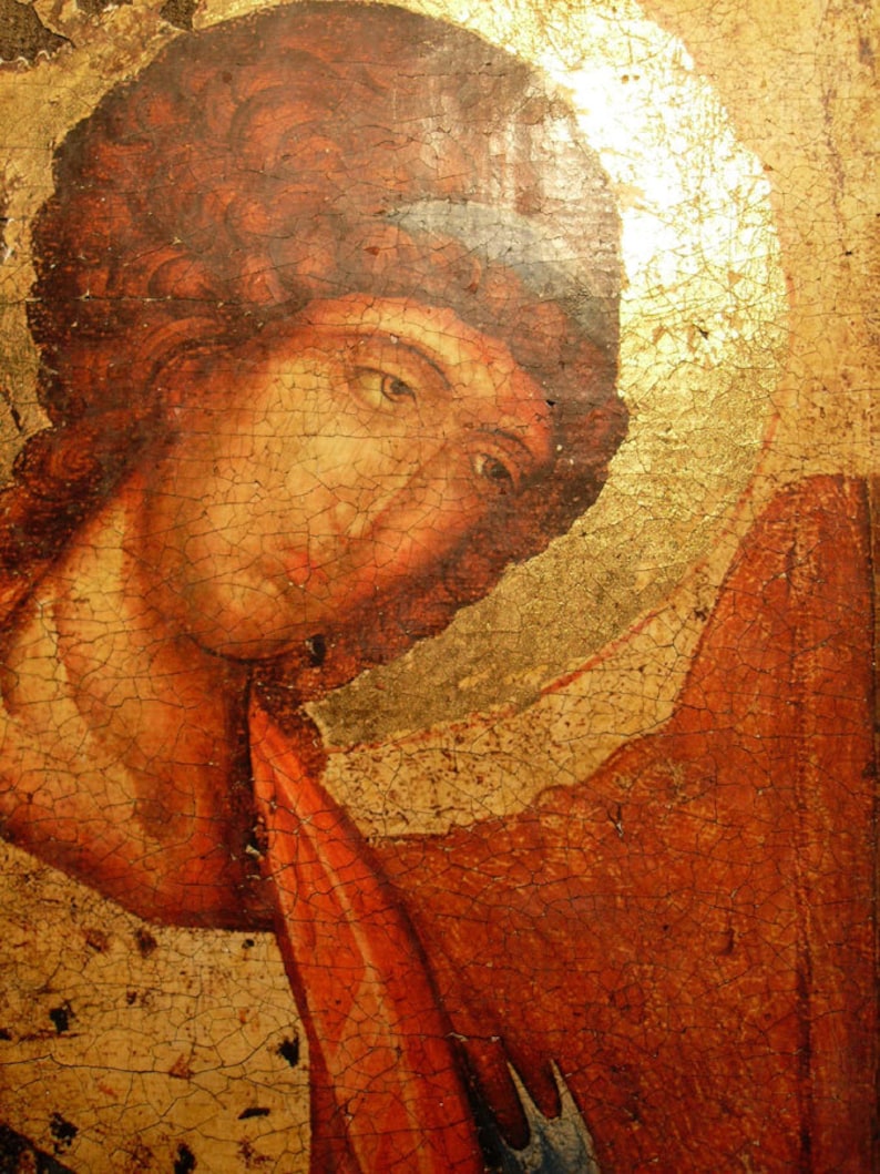 May include: A close-up of a painting depicting a person with red hair and a red and gold robe. The painting is on a wooden panel and has a cracked and aged appearance.