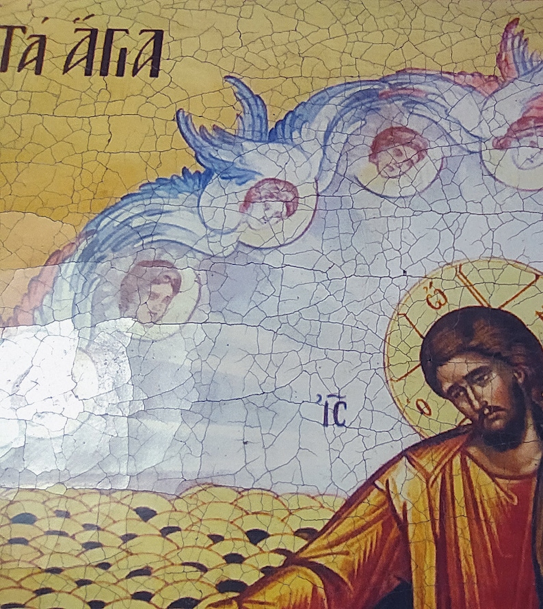 May include: A vintage religious icon painting depicting Jesus Christ with a halo and a yellow robe. The painting is on a cracked, yellow background with blue and white clouds and angels. The text "T&aacute; &aacute;lla" is written in black at the top of the painting.