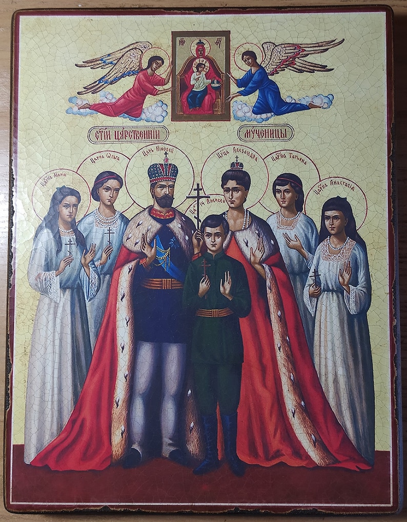 May include: A religious icon depicting a family with a red, gold, and blue color scheme. The icon features a central figure with a crown and a red robe, surrounded by other figures in white and blue robes. The icon is painted on a wooden panel with a light yellow background.