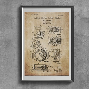 May include: Framed vintage patent print from the United States Patent Office, dated December 4, 1951. The sepia-toned print features detailed technical drawings of a device, including diagrams labeled Fig. 1 through Fig. 7. The print is encased in a black frame.