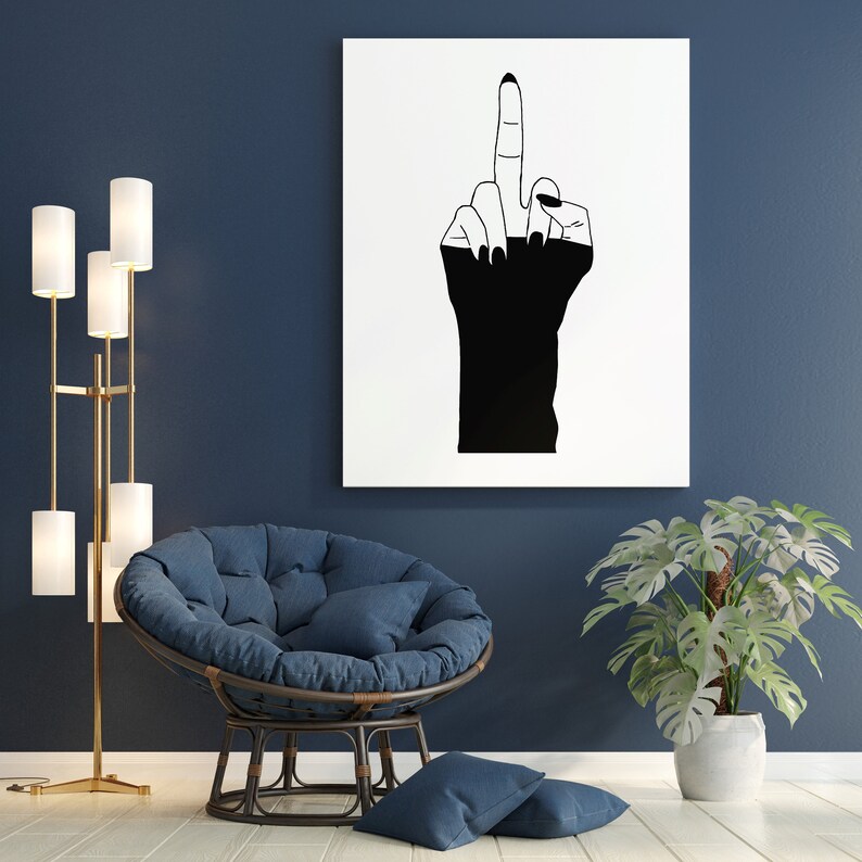 May include: A black and white line drawing of a hand giving the middle finger, printed on a white canvas and framed. The canvas is hanging on a dark blue wall above a blue beanbag chair.