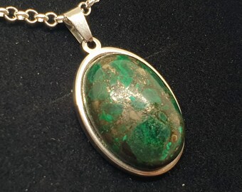 May include: A silver chain necklace with a green oval pendant featuring a malachite stone with gold flecks.