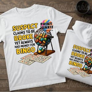 May include: A white t-shirt and a white hooded sweatshirt featuring a graphic of a bingo cage filled with colorful balls, two bingo cards, and the text: SUSPECT CLAIMS TO BE BROKE YET ALWAYS HAS MONEY FOR BINGO, along with the logo PRINT JUNKIE.