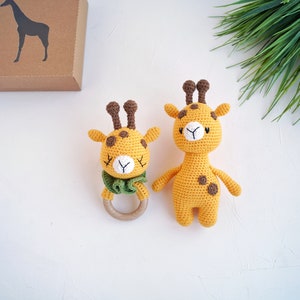 May include: Two crocheted giraffe toys. One is a rattle with a wooden ring and the other is a larger stuffed toy.