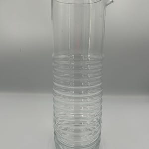 May include: A set of three ceramic mugs with a speckled, matte finish. Each mug features a different color: light blue, cream, and gray. The mugs have a simple, modern design and a comfortable handle. Perfect for coffee or tea.