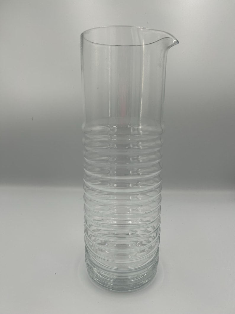 May include: A set of three ceramic mugs with a speckled, matte finish. Each mug features a different color: light blue, cream, and gray. The mugs have a simple, modern design and a comfortable handle. Perfect for coffee or tea.