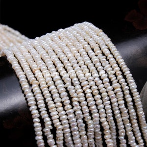 May include: A strand of white freshwater pearls, each pearl is approximately 4-5mm in size. The pearls are strung on a white thread and are ready to be used for jewelry making.