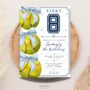 May include: A softball-themed birthday invitation with three yellow softballs adorned with light blue bows. The invitation features the number "8" in navy blue, along with the text "Avery's 8th Birthday". The invitation is set on a wooden tray.