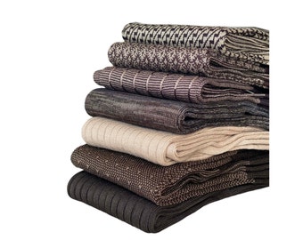 May include: A stack of six pairs of brown and beige socks with different patterns. The socks are folded and stacked on top of each other.