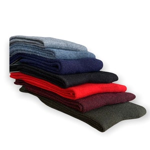May include: A stack of six pairs of socks in various colors, including gray, navy blue, black, red, burgundy, and dark green.