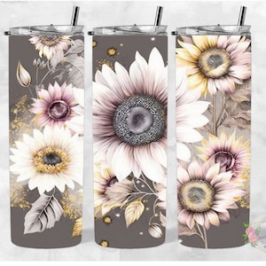 May include: Three gray and white stainless steel tumblers with a floral design featuring sunflowers and pink flowers. The tumblers have a gold glitter effect.