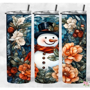 May include: A set of three stainless steel tumblers with a winter-themed design. The tumblers feature a snowman with a red scarf and a blue background with white flowers and orange roses.
