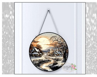 May include: A round wooden sign with a winter scene painted on it. The scene features a snowy landscape with two small houses, a river, and a large, bright moon in the sky. The sign is hanging from a white rope.
