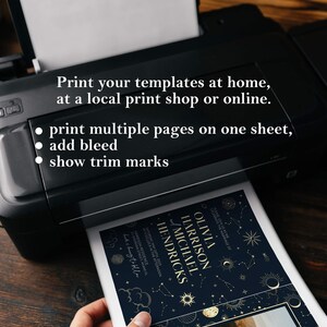May include: A printer printing a wedding invitation with a celestial theme. The invitation features a dark blue background with gold stars, moons, and planets. The text on the invitation reads "Olivia Harrison and Michael Hendricks".