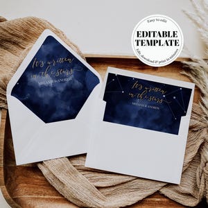 May include: A white envelope with a dark blue watercolor night sky liner and a matching rectangular card. Both feature the gold script text It's written in the stars and the names Melanie & Andrew. A circular badge reads EDITABLE TEMPLATE.