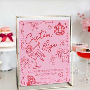 May include: A pink custom sign in a gold frame. The sign features red illustrations of a woman in a martini glass, a disco ball, and other decorative elements. Text on the sign reads "Custom Sign" and "Use this template to display any custom text".