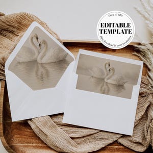 Può includere: Buste bianche con un disegno di cigni all'interno, presentate su un vassoio di legno con tessuto beige. Le buste presentano un'immagine color seppia di due cigni sull'acqua. È visibile anche il testo "Easy to edit EDITABLE TEMPLATE Edit, download & print in minutes".